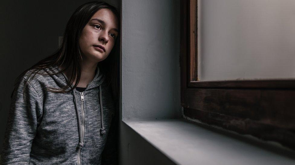 Girl looking out of window