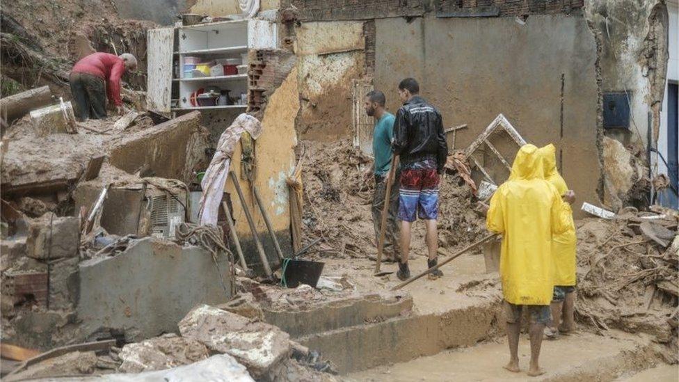 Men work on the wreckage of a house that collapsed during a landslide caused by heavy rains at Jardim Monte Verde, in Ibura neighbourhood, in Recife, Brazil, May 28, 2022.