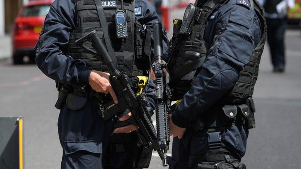 Armed police stand guard near London Bridge station following an attack in the capital, 4 June 2017