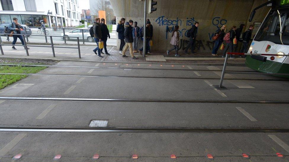 Traffic crossing with red lights in the pavement