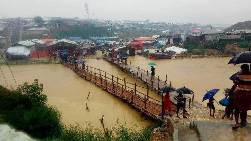 Floodwater runs through the camp