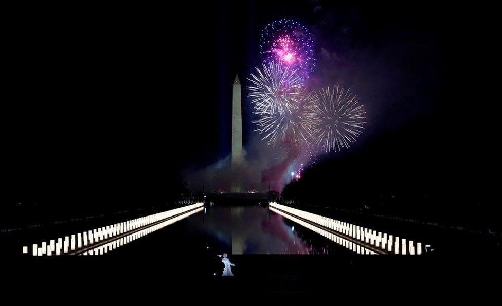 Katy Perry (foreground) performs amid the fireworks at the Washington Monument at a televised ceremony at the Lincoln Memorial on January 20, 2021 in Washington, DC.