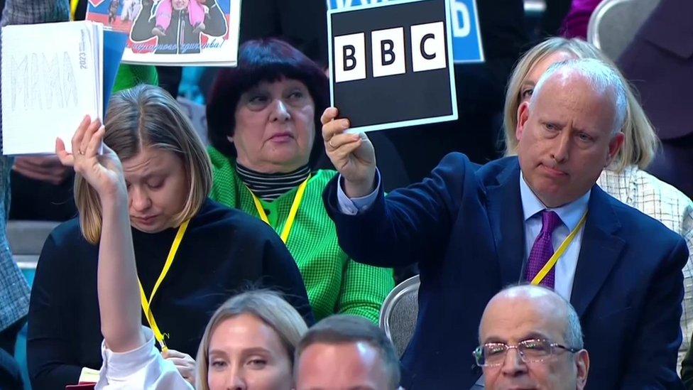 Steve Rosenberg holding a BBC sign