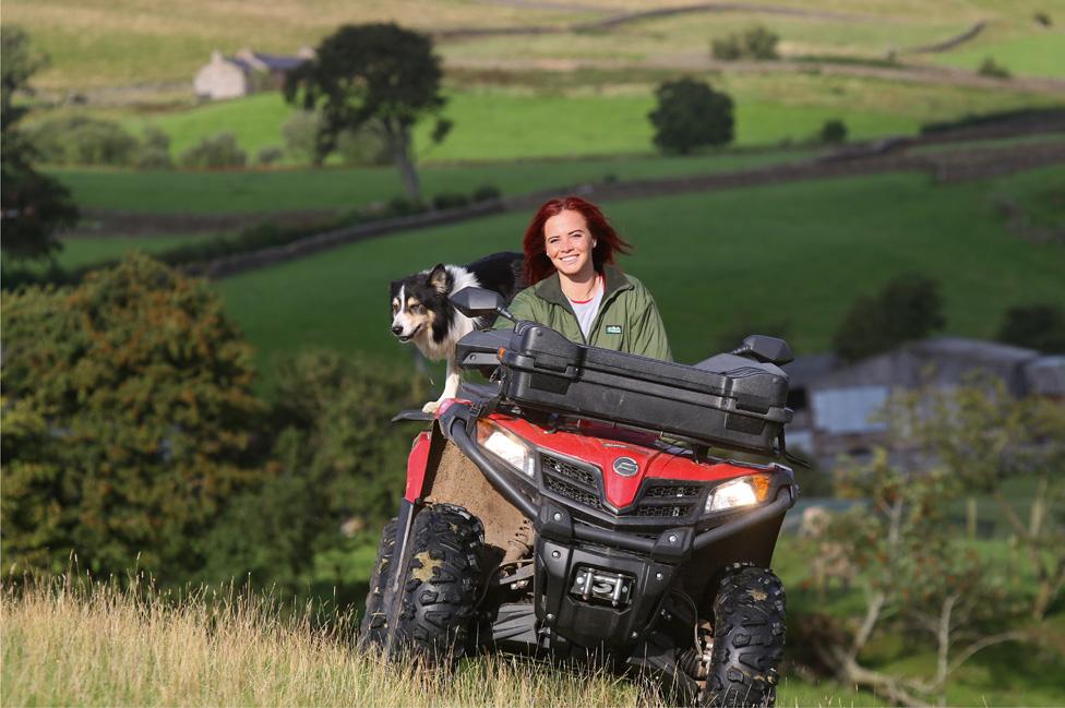 Hannah Jackson on her quad bike with her dog