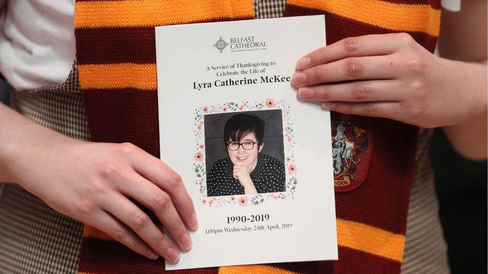 A mourner wearing a Gryffindor scarf holds an order of service as she arrives for the funeral service of murdered journalist Lyra McKee in St Anne's Cathedral in Belfast