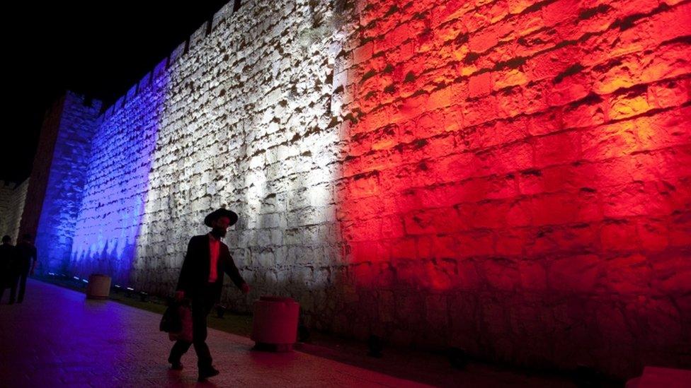 Jerusalem's Old City wall illuminated with the colours of the French flag