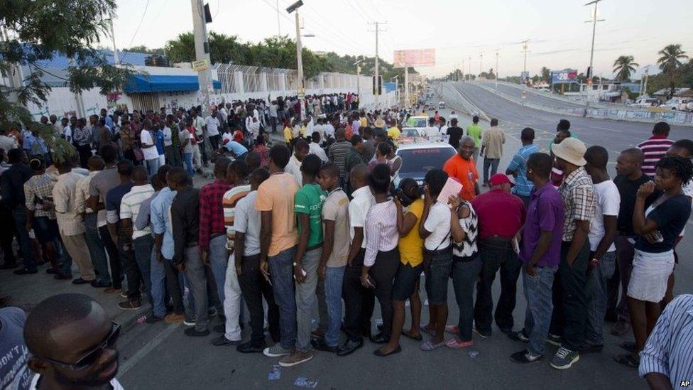 People stand in line to vote in Port-au-Prince