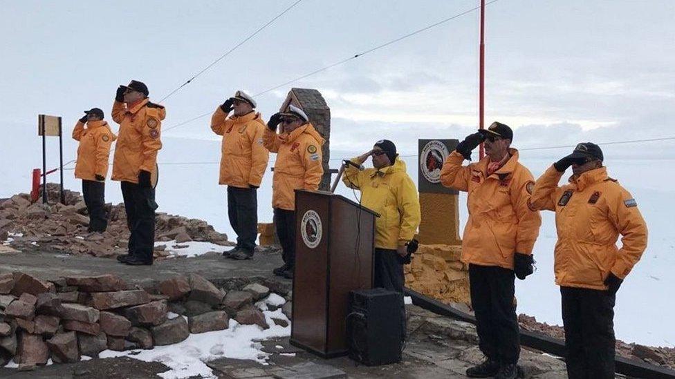 Members of the crew of the ARA Iríza salute during a ceremony