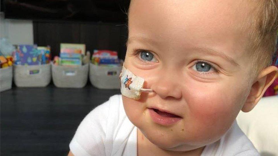 Blue-eyed Alessandro Montresor looks to the side of the camera with a tube in his nose