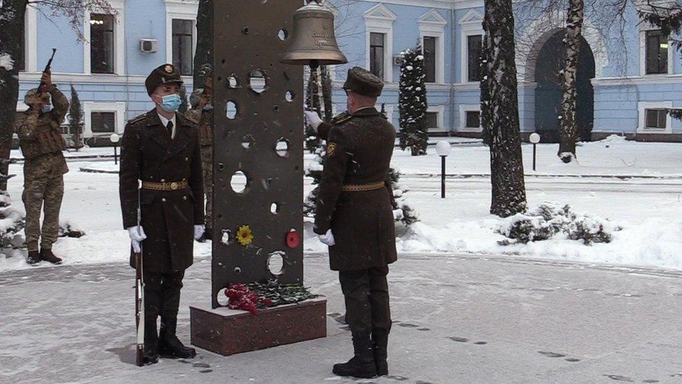 Soldiers take part in a commemoration ceremony in Kyiv