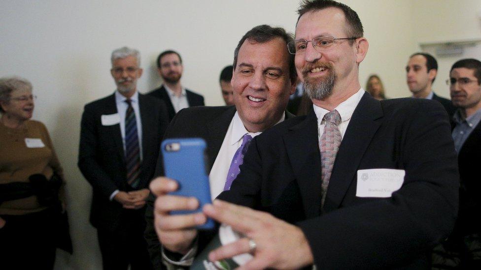 U.S. Republican presidential candidate and New Jersey Governor Chris Christie (C) poses for a selfie before speaking at the New Hampshire Forum on Addiction and Heroin Epidemic in Hooksett, New Hampshire, January 5, 2016.