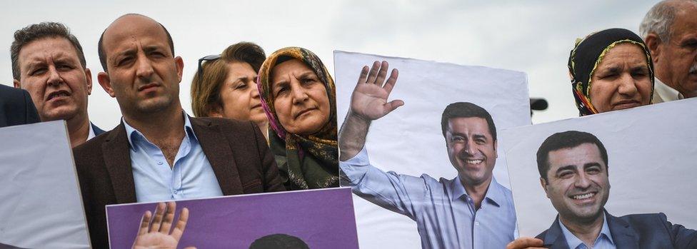 Supporters of pro-Kurdish Peoples" Democratic Party (HDP) hold portraits of jailed ex-HDP leader Selehattin Demirtas on May 25 , 2018