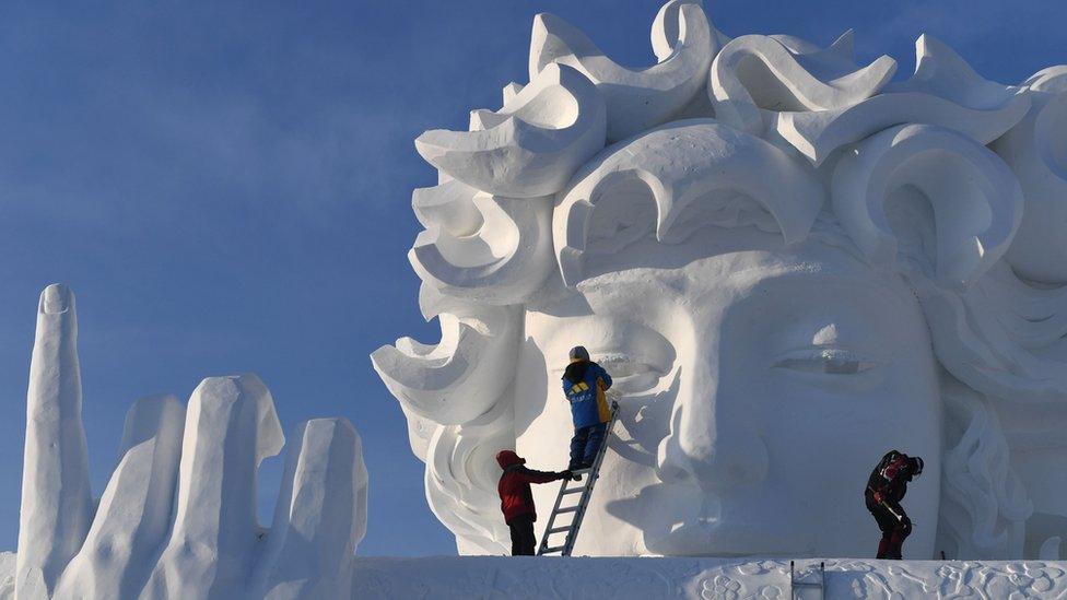 Workers putting the finishing touches to one of the artworks.