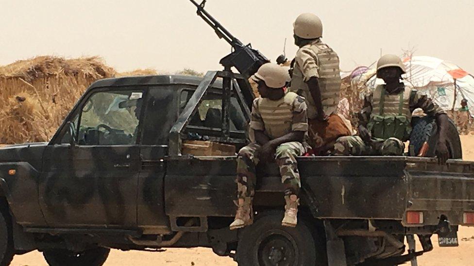 Niger soldiers on flatbed truck with mounted gun in Diffa, Niger