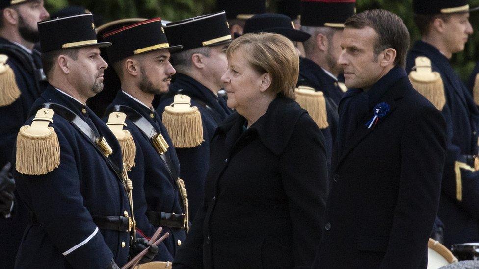 French President Emmanuel Macron and German Chancellor salute French soldiers as they attend a ceremony at the glaze of the Forest of Rethondes in Compiegne, France, 10 November 2018