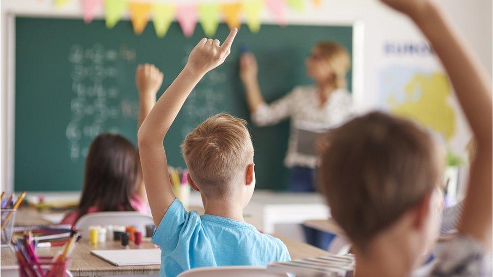 Photo of all kids putting hands up - stock photo