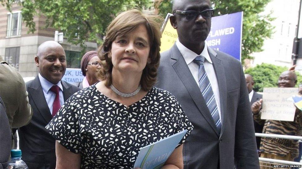 British lawyer Cherie Blair (L), wife of former prime minister Tony Blair, arrives carrying a folder with the word 'Rwanda' written on it at Westminster Magistrates Court in London on June 25, 2015