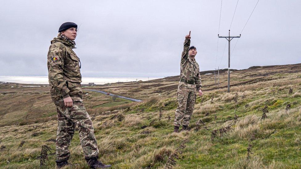 Members of the armed forces check on overhead power cables in Weardale, County Durham