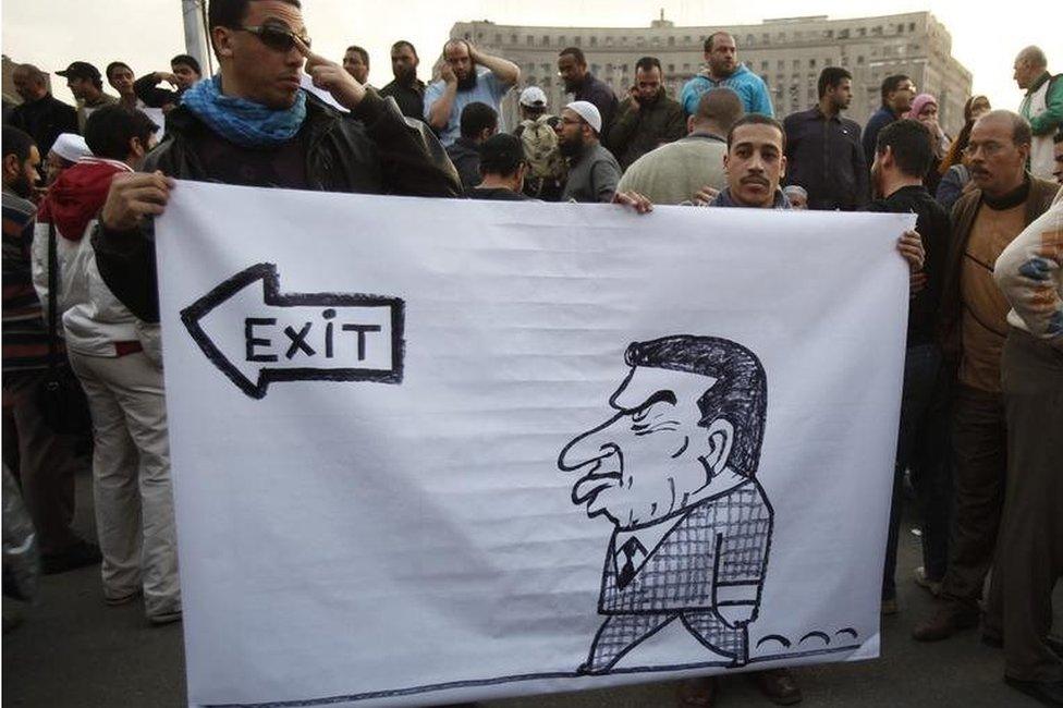 Protesters hold caricature of Egyptian President Hosni Mubarak in Cairo in 2011