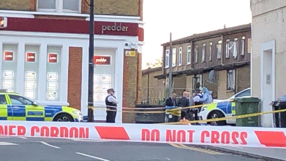 A police cordon in Sydenham Road, south-east London, after a man in his twenties was found with gunshot wounds and died at the scene on Sunday afternoon.