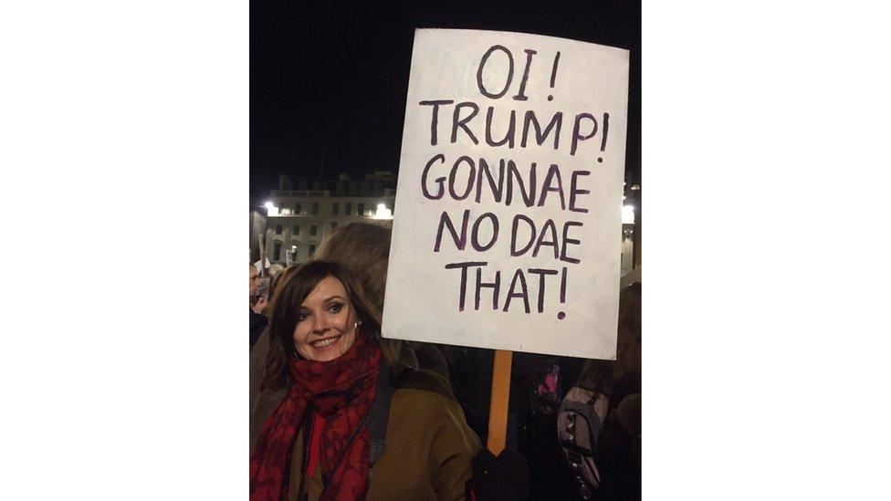 A protester at the Trump travel ban demo in Glasgow with a sign saying 'Oi Trump, gonna no dae that'