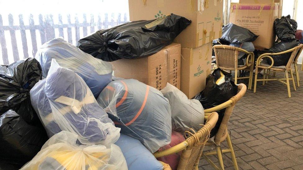 Bags of clothing piled up in car park at Railway Tavern in Dereham