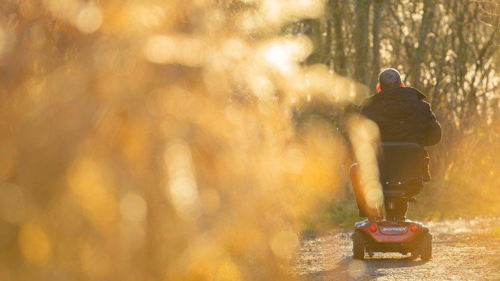 A man on a mobility scooter