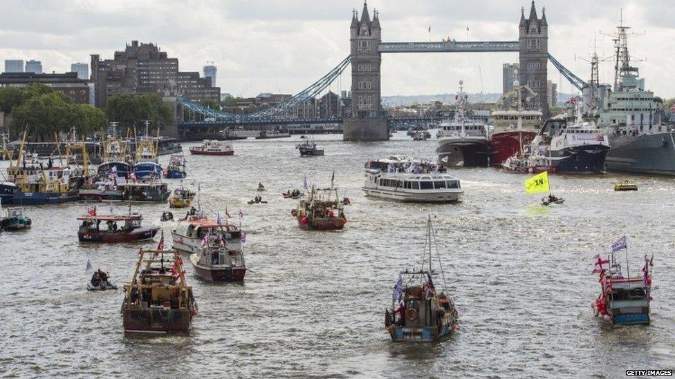 Flotilla of boats approaching Tower Bridge