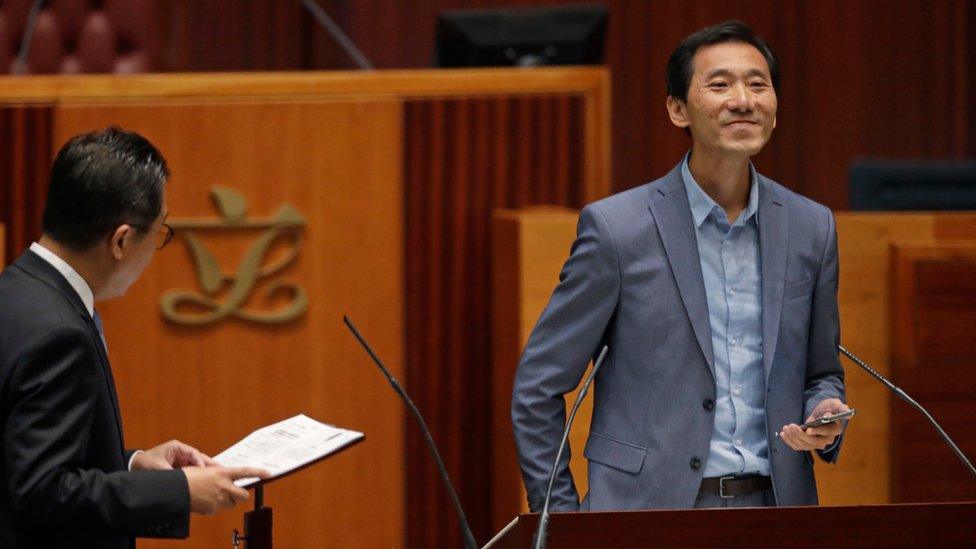 Newly elected pro-democracy lawmaker Edward Yiu Chung-yim smiles as he takes oath in the new legislature Council in Hong Kong, Wednesday, Oct. 12, 2016