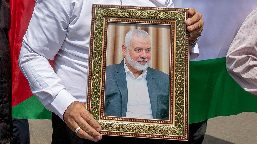 Iranian protester carrying picture of assassinated Hamas leader, Ismail Haniyeh 