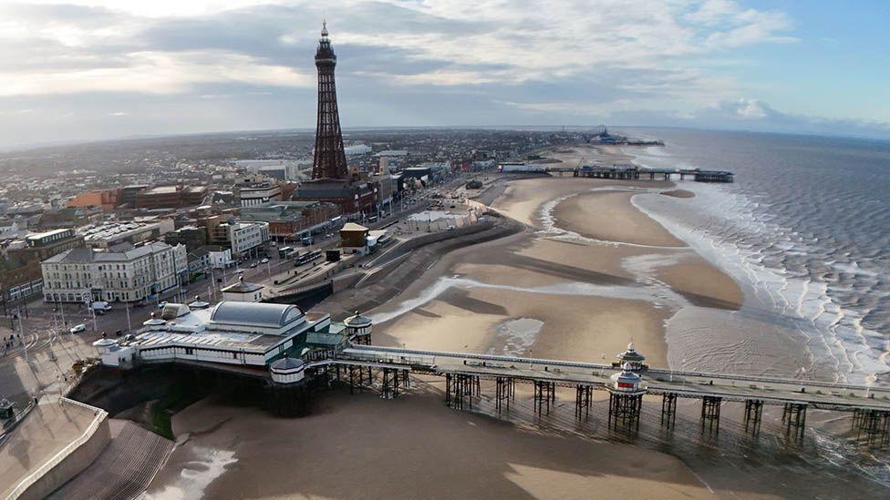 View of Blackpool from the air, showing the beach, Blackpool Tower and the piers