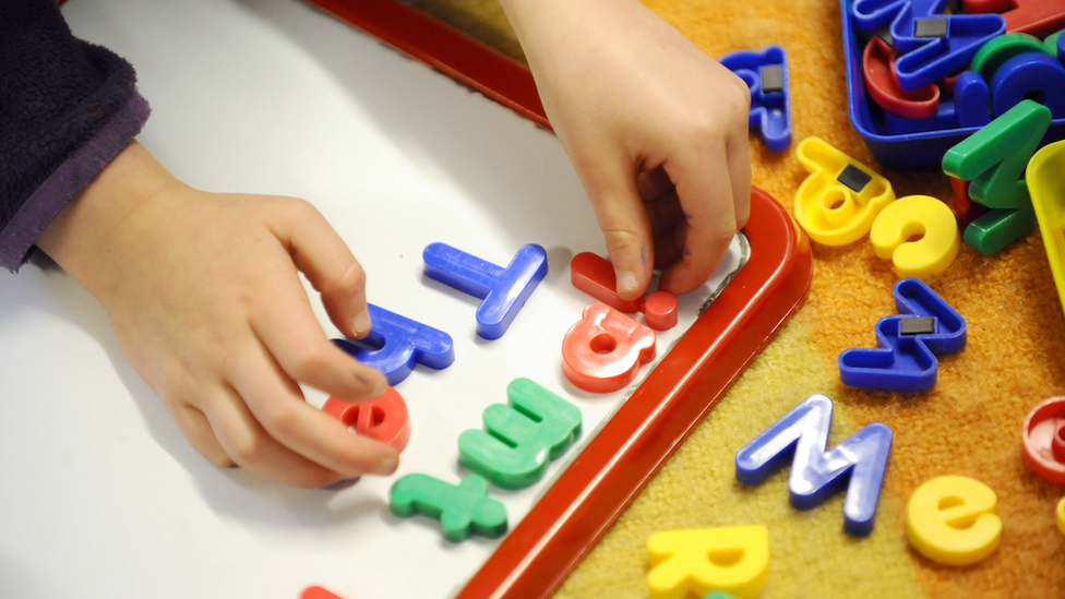 Child playing with letters