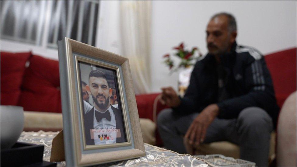 Yasser Hamdan and a pic of his son