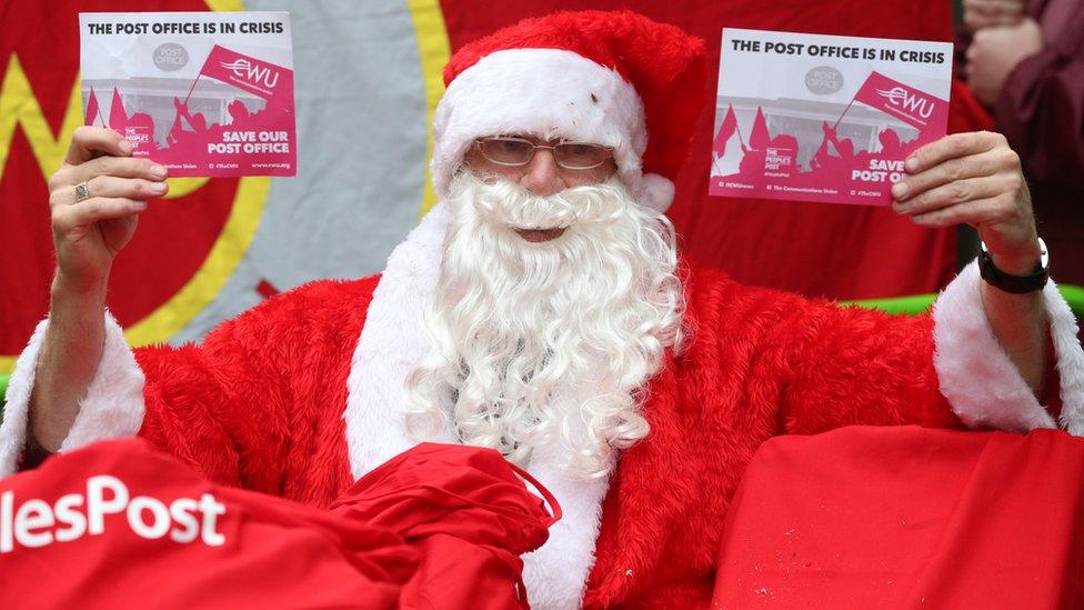 Post office worker in Santa outfit