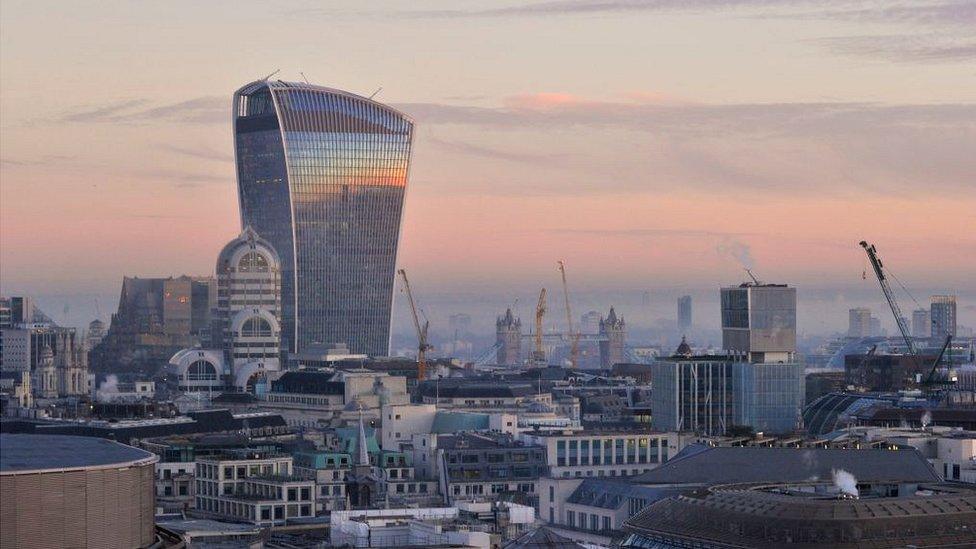 The sun sets over the city of London