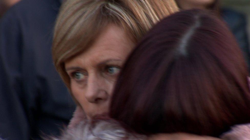 Relatives of Michael McGibbon comforted each other at the vigil at Holy Cross