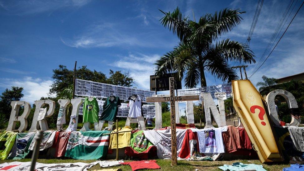 Tributes, posters and personal objects of victims of the dam collapse at a nearby iron-ore mine