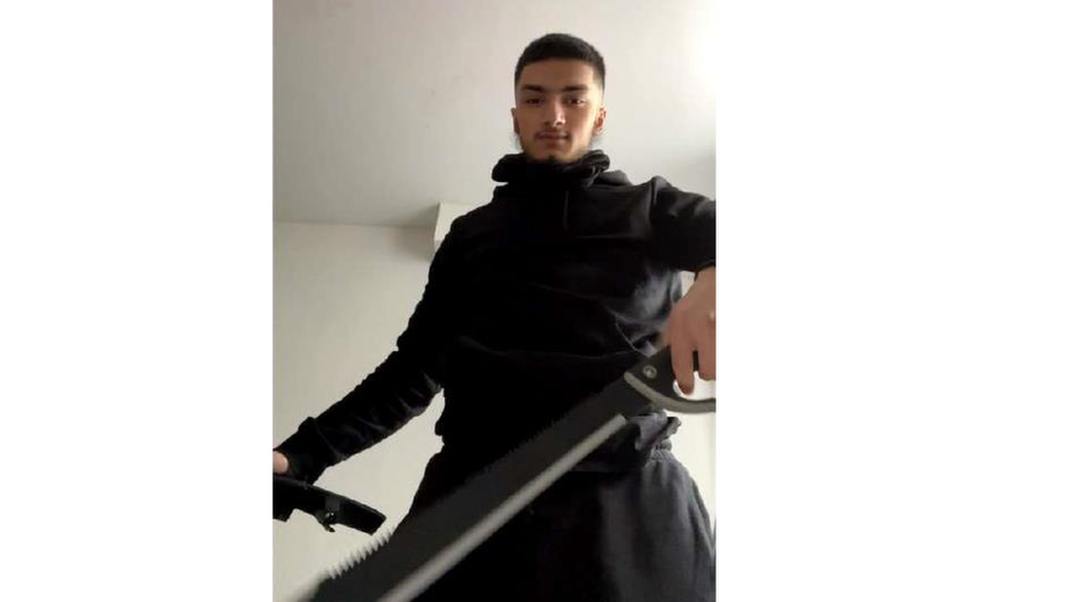 Hassan posing with a sword