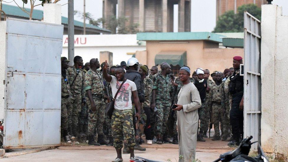 Mutineer soldiers stand at entrance to deputy prefect's residence in Bouake, Ivory Coast. 7 January 2017