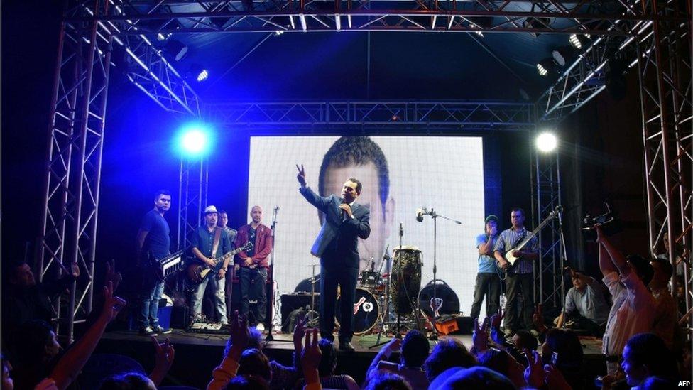 Guatemalan presidential candidate for the National Front of Convergence (FCN) party, Jimmy Morales (C), speaks to supporters after the preliminary results for the general elections, at their party headquarters in Guatemala City early on 7 September 2015.