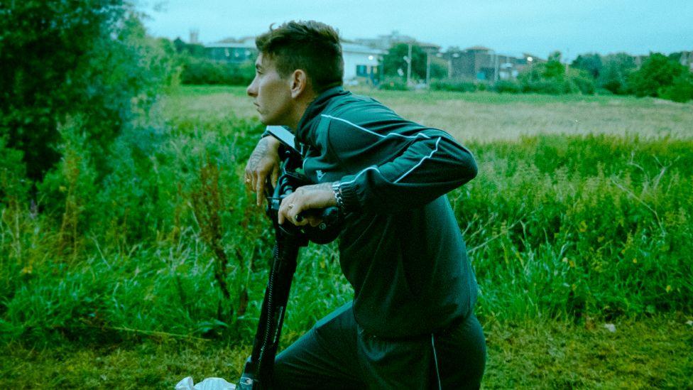 Barry Keoghan as Bug in Bird, pictured riding a scooter