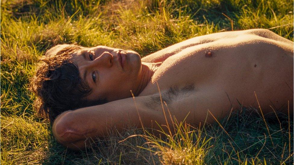 Barry Keoghan lying shirtless in Saltburn