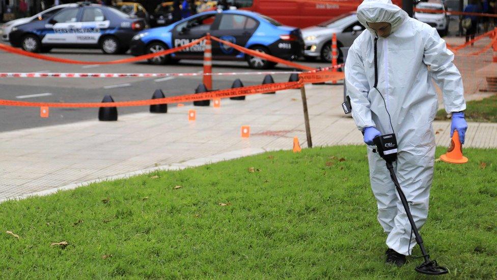 Forensic police officers are looking for evidence at the crime scene after an attack injured Argentine deputy Hector Olivares and killed his advisory Marcelo Yadon near the Congress building in Buenos Aires, 9 May 2019