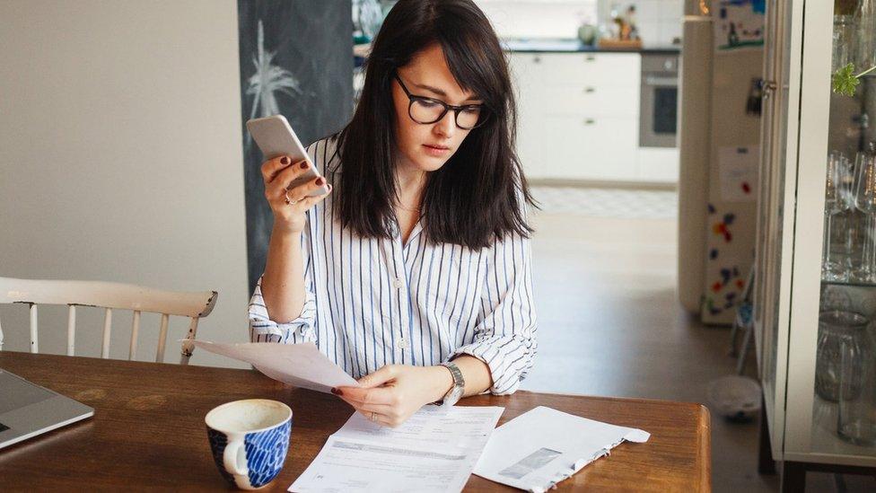 woman looking at bills