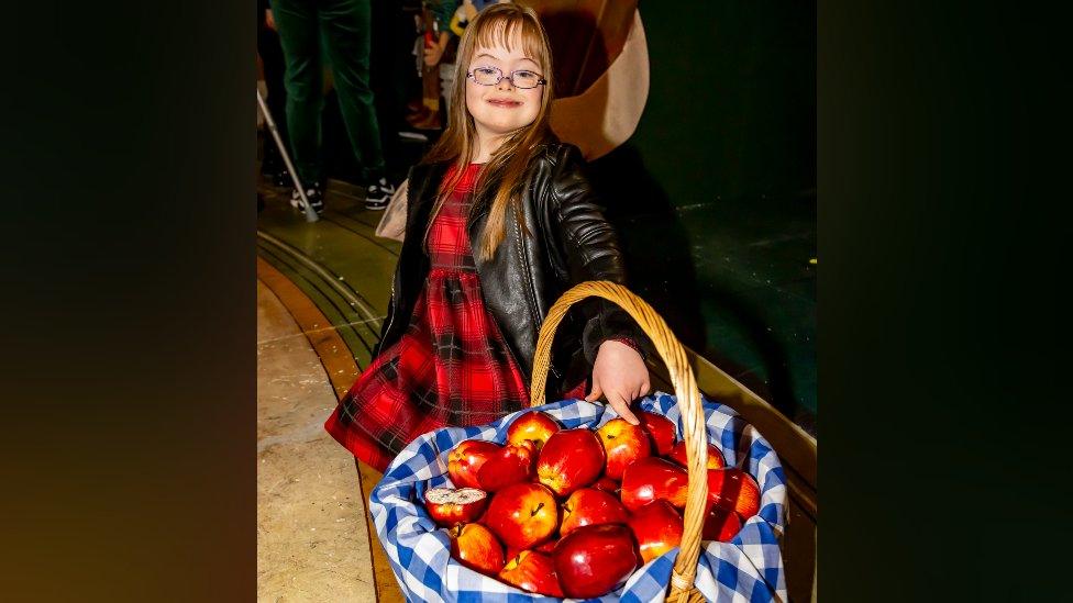 Two girls with theatre prop of Snow White's apples