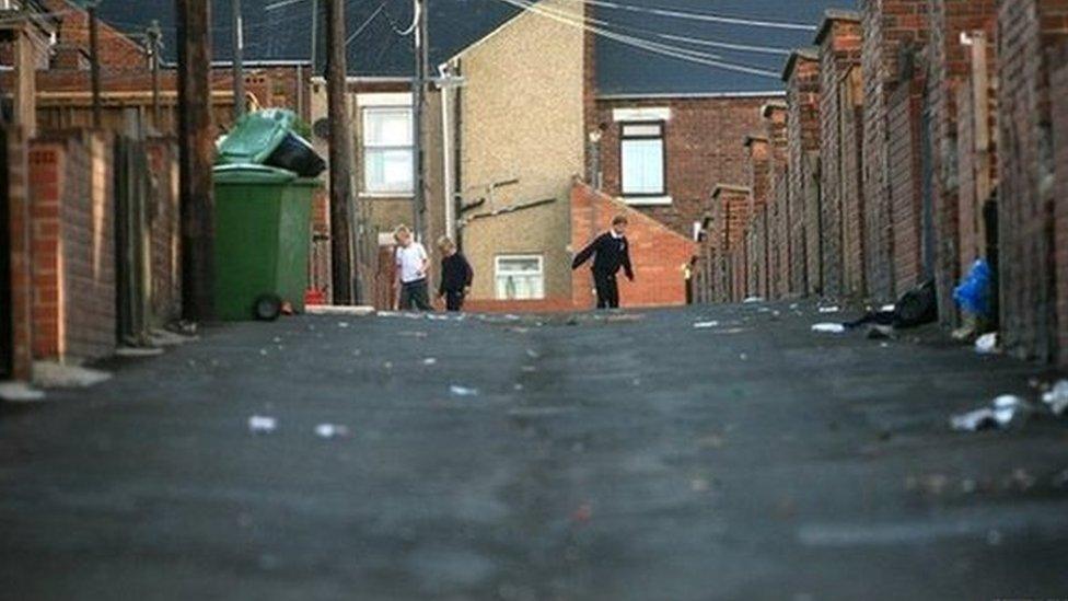 Children playing on a run-down street