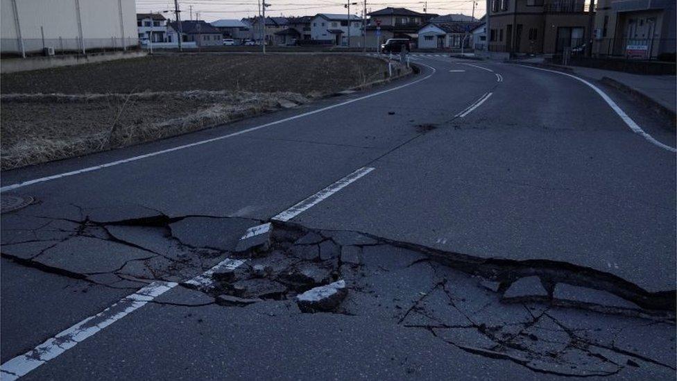 A broken road following a strong earthquake is pictured in Soma, Fukushima prefecture, Japan in this photo taken by Kyodo on March 17, 2022.