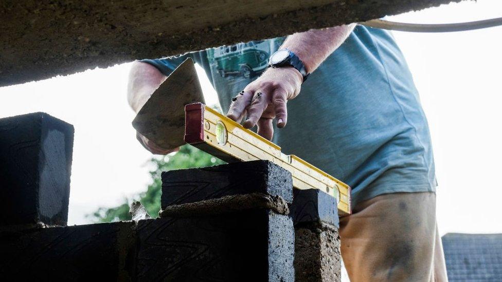 Worker using spirit level