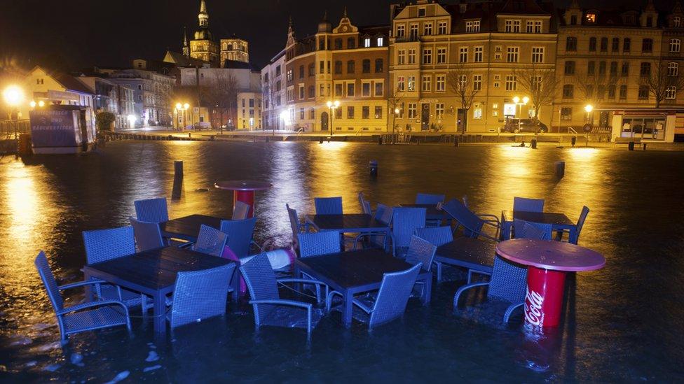 Furniture of a restaurant is surrounded by flood water in the harbour at Stralsund, northern Germany (5 Jan)