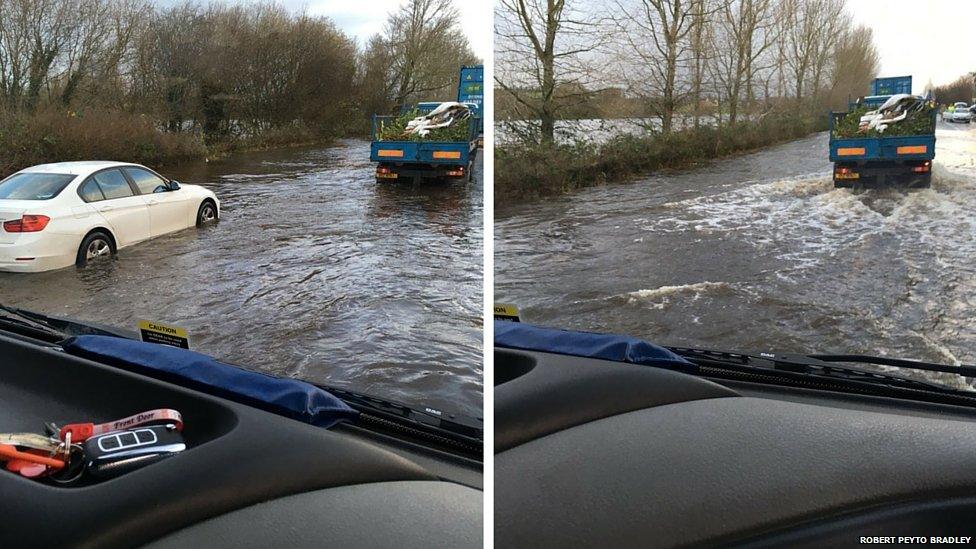 Cars driving on flooded roads between Armagh